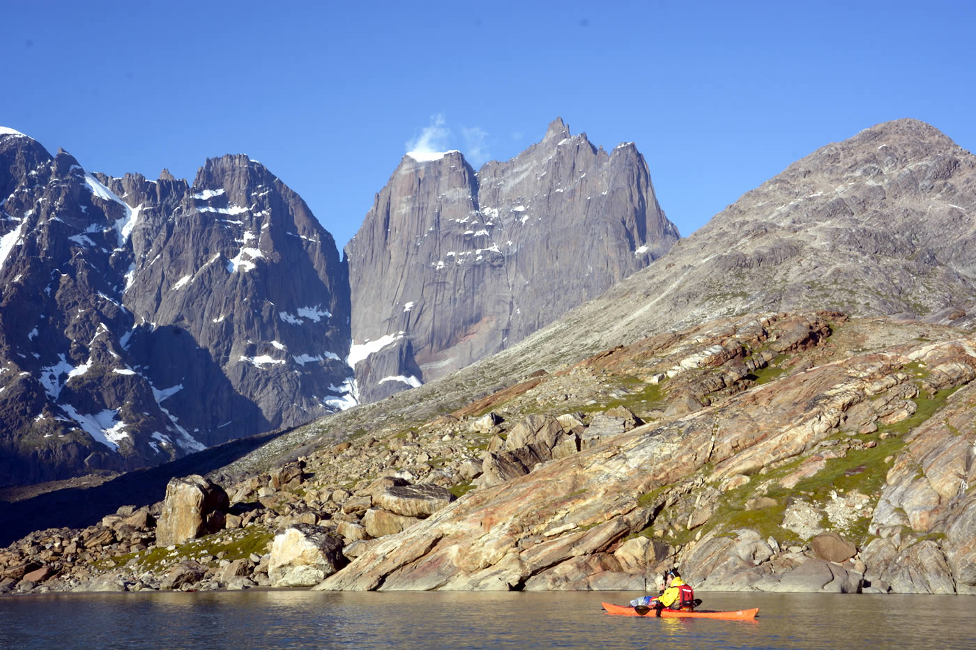 Christian Laddy Ledergerber arriving after seven days of intense paddling. Basecamp was at the foot of the big boulder. The Apostelens Tommelfinger and its 2000-meter west face looms in the background. [Photo] Silvan Schuepbach Ledergerber paddle in the North Atlantic Ocean. [Photo] Silvan Schuepbach