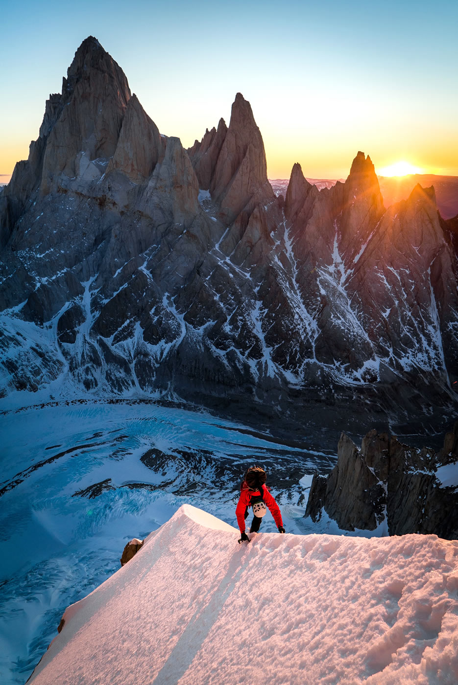 Leclerc climbs up the snowfield above the bivy site at sunrise on day two. [Photo] Austin Siadak