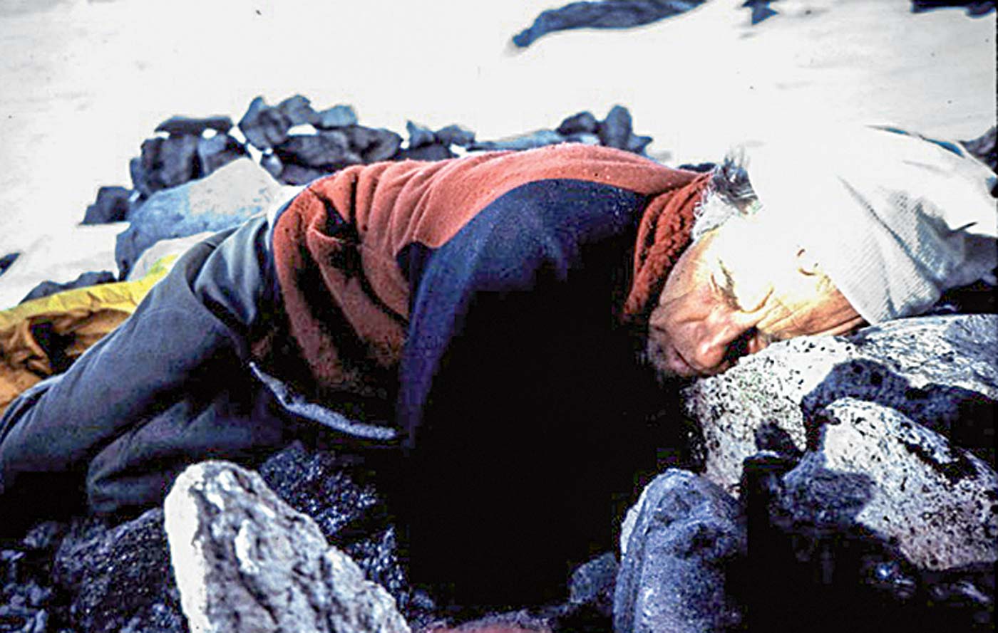 Beckey rests after the approach to Mt. Goode, with a rock for a pillow. [Photo] Douglas McCarty