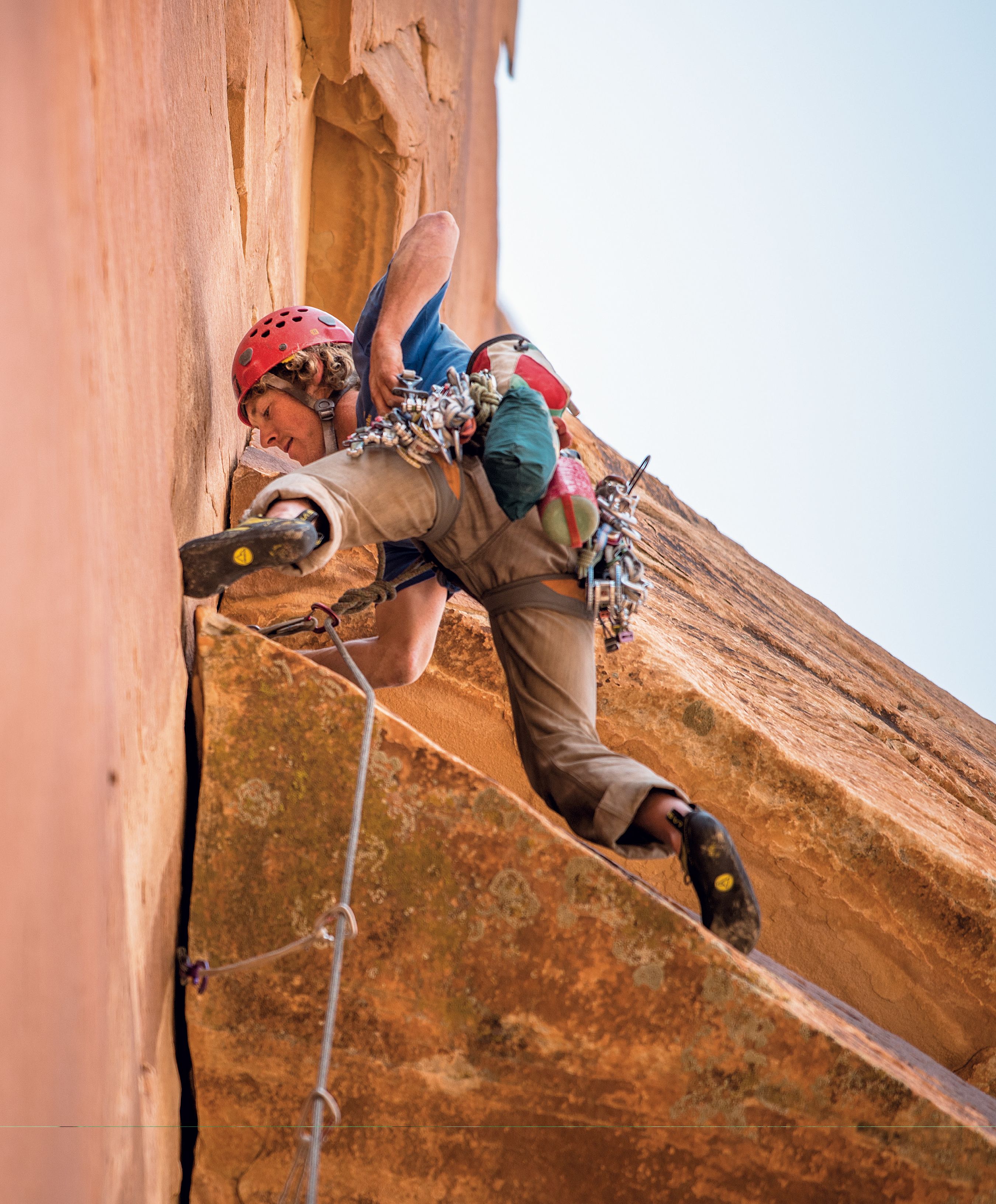 Harrison on the fourth pitch of Zoroaster Temple's Southeast Face. In the 2016 American Alpine Journal, Harrison reported that the free ascent of the route had been a 'serious' project of mine ever since Mathieu Brown and I established the route in 2012. Harrison returned with Alwyne Butler in 2013 to attempt a free ascent. During that trip, they managed to remove the aid from all except Pitch 3 of the five-pitch climb. In April 2015, the day after Harrison, author Jeff Snyder and Blake McCord completed the free ascent, they climbed to the top of Zoroaster a second time to refill the summit register's stash of whisky. [Photo] Blake McCord