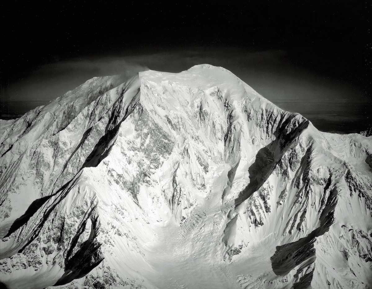 The southeast face of Mt. Foraker (Sultana). The middle and upper part of the Infinite Spur (Alaska Grade 6: 5.9 M5 AI4, 9,400', Kennedy-Lowe, 1977) rises out of the basin on the left. The Southeast Ridge, where Kennedy and George Lowe descended, is on the right. The Infinite Spur remains one of the most legendary alpine routes. [Photo] Bradford Washburn, Bradford Washburn collection, Museum of Science