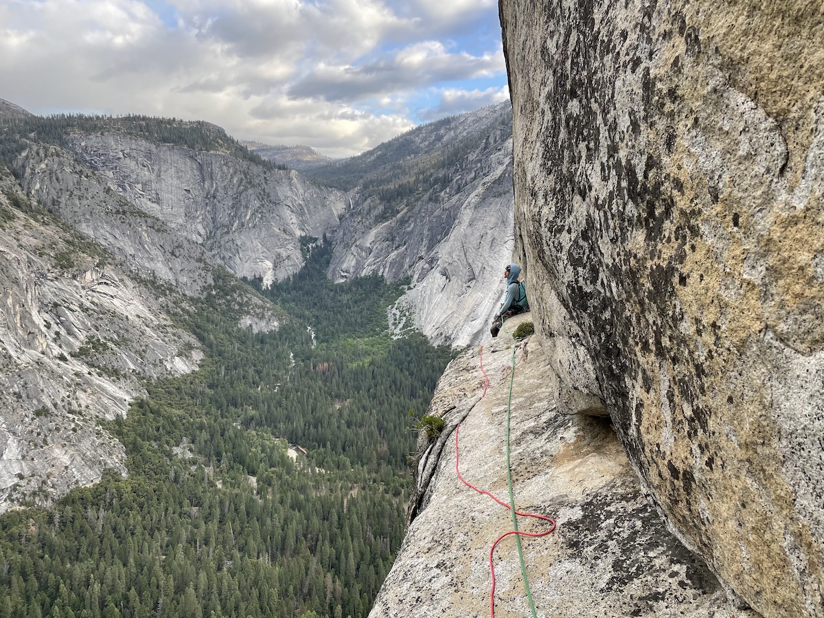Isaac Kroger rests on the ledge below the last pitch of Astroman (5.11c, 10 pitches), May 20, 2021, with Derek Franz. Kroger climbed the historic testpiece on his first try. Two days earlier, he and his partner Spenser Platt had completed the Nose of El Capitan (Tu-Tok-A-Nu-La) in a day for their first time. [Photo] Derek Franz