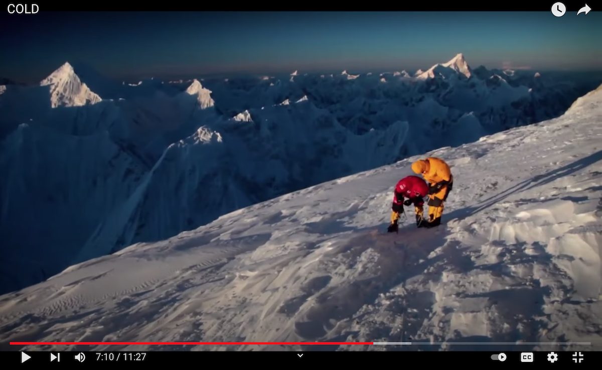 This screenshot from the 2011 film Cold shows the team of Cory Richards, Simone Moro and Denis Urubko near the summit of Gasherbrum II (8034m) during the first winter ascent of the peak. Image used with permission from film director Anson Fogel.