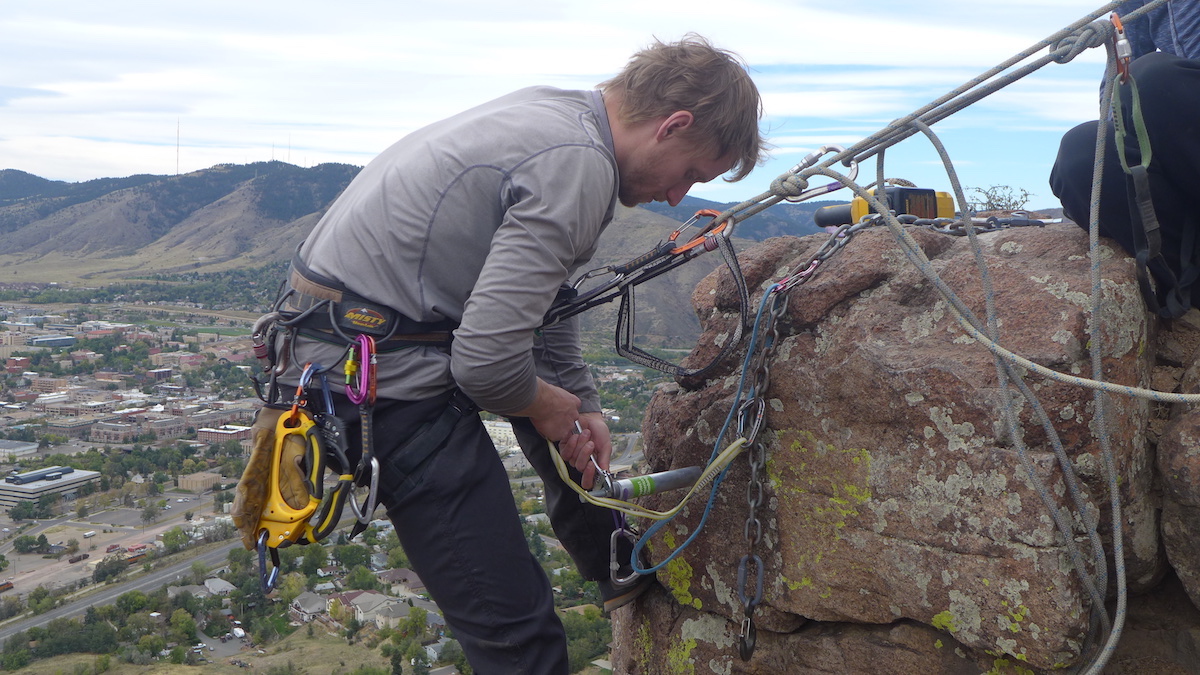 A volunteer with the Boulder Climbing Community replaces bolts on North Table Mountain above Golden, Colorado. [Photo] Jason Haas