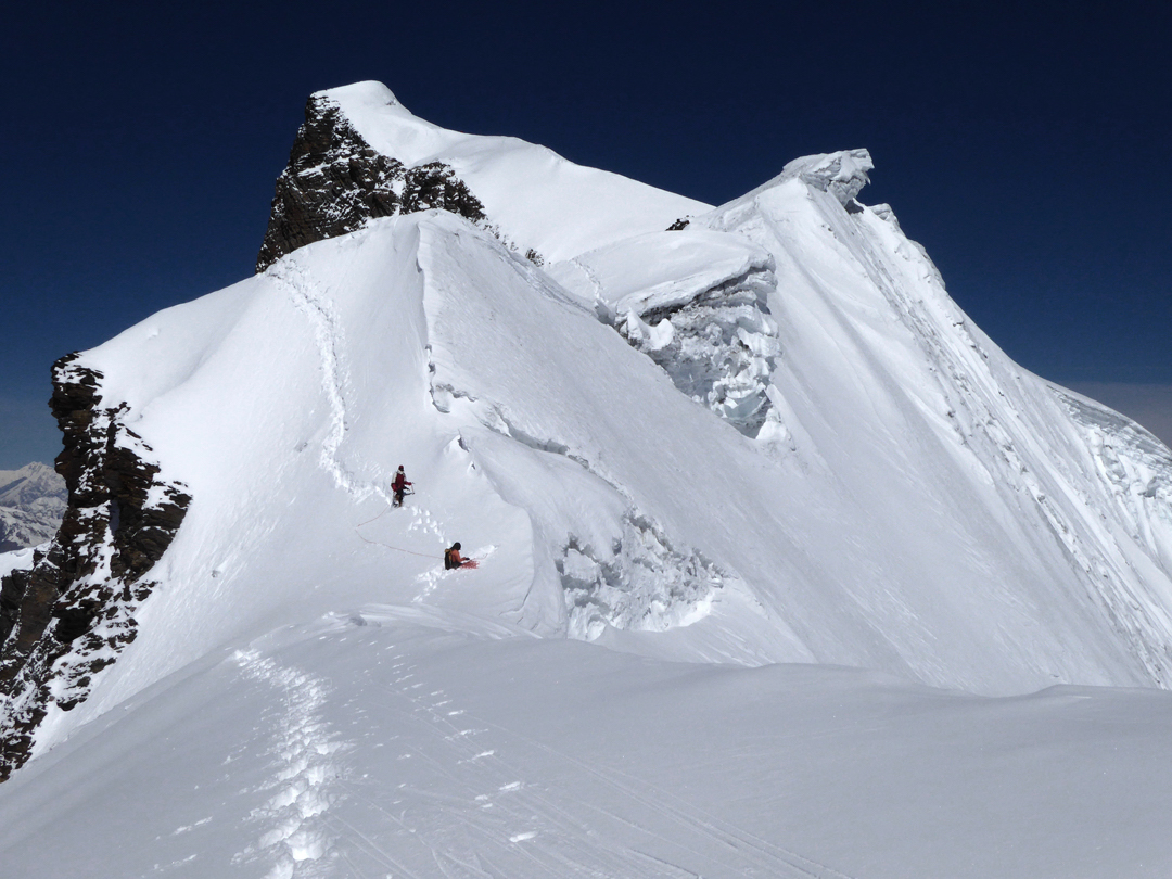 Isabelle Guillaume and Jangbu Sherpa descending the east ridge of Himlung Himal (summit visible behind) en route to the first ascent of Himlung East. [Photo] Paulo Grobel