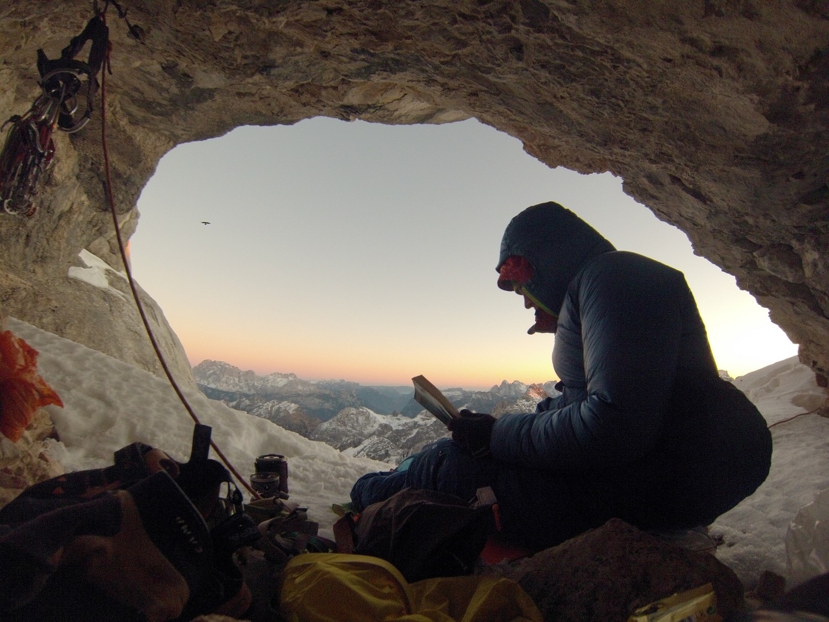 Ballard enjoys some reading on the comforts of a bivy ledge during his rope-solo of the Gogna Route (5.10, 800m) on Marmolada Punta Rocca (3309m), Dolomites, Italy. [Photo] Tom Ballard