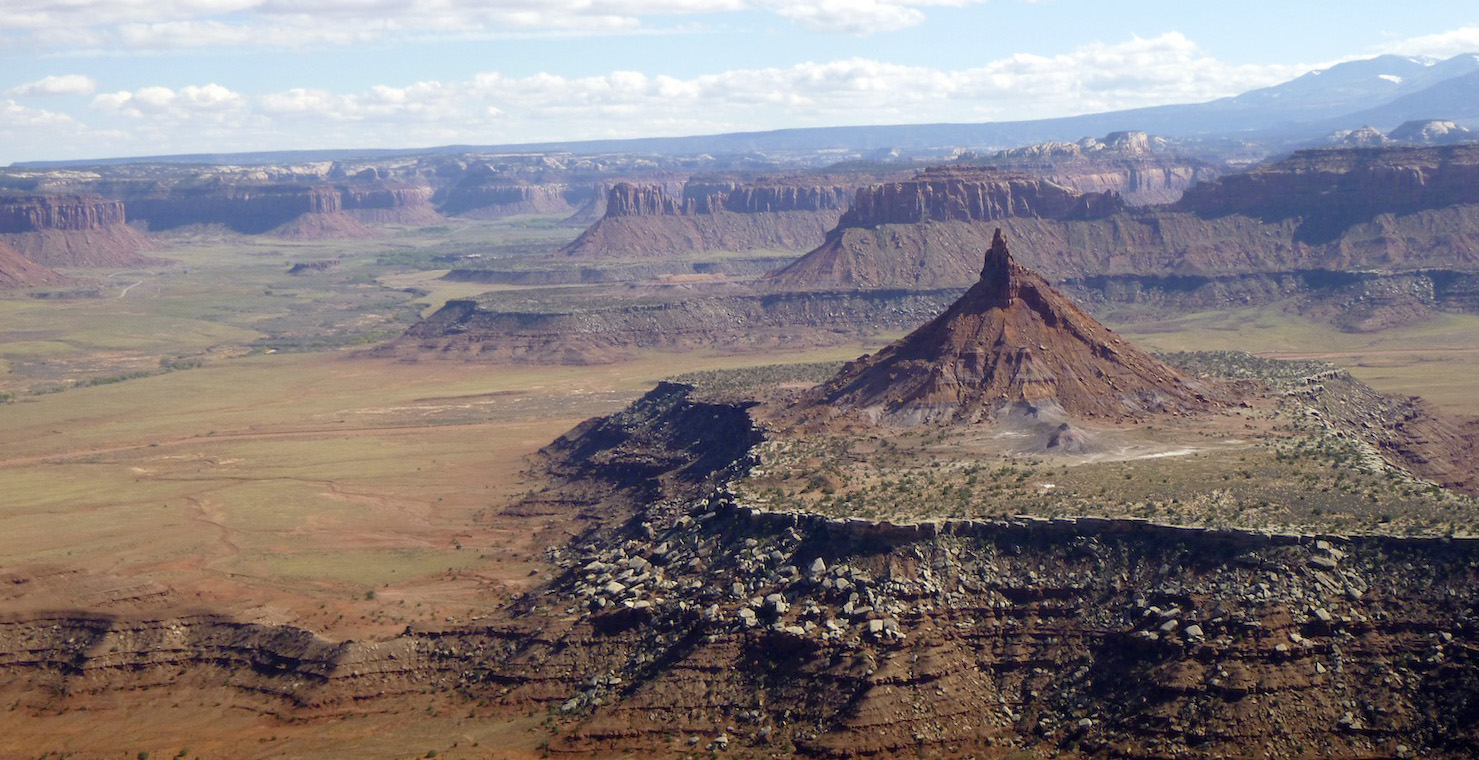 Looking east from the summit of North Six Shooter provides a glimpse of the 1.35-million-acre Bears Ears National Monument. South Six Shooter is in the foreground and Bridger Jack Butte and pinnacles are in the middle ground. The Abajo Mountains are in the background to the right and the La Sal Mountains are just out of view to the left. [Photo] Derek Franz