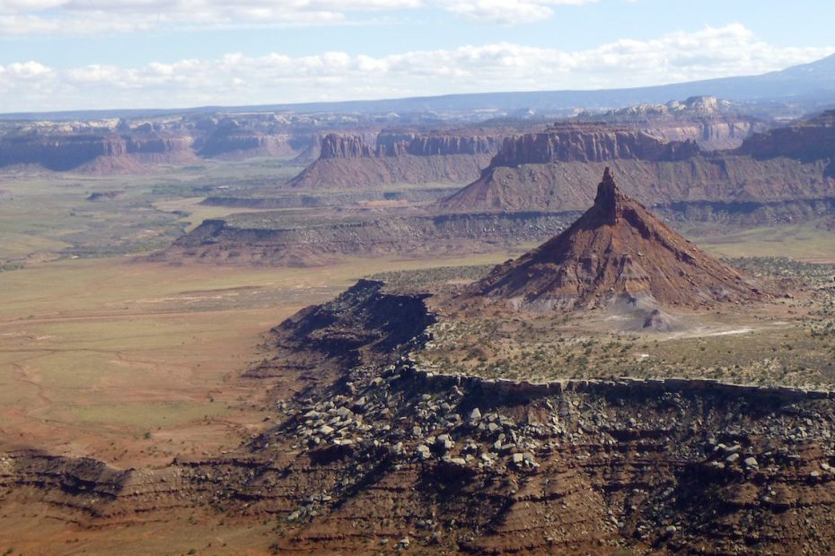 Looking east from the summit of North Six Shooter in Indian Creek, Utah, provides a glimpse of the 1.35-million-acre Bears Ears National Monument. South Six Shooter is in the foreground and Bridger Jack Butte and pinnacles are in the middle ground. The Abajo Mountains are in the background to the right and the La Sal Mountains are just out of view to the left. Canyonlands National Park lies behind the photographer, just a few miles to the west. [Photo] Derek Franz