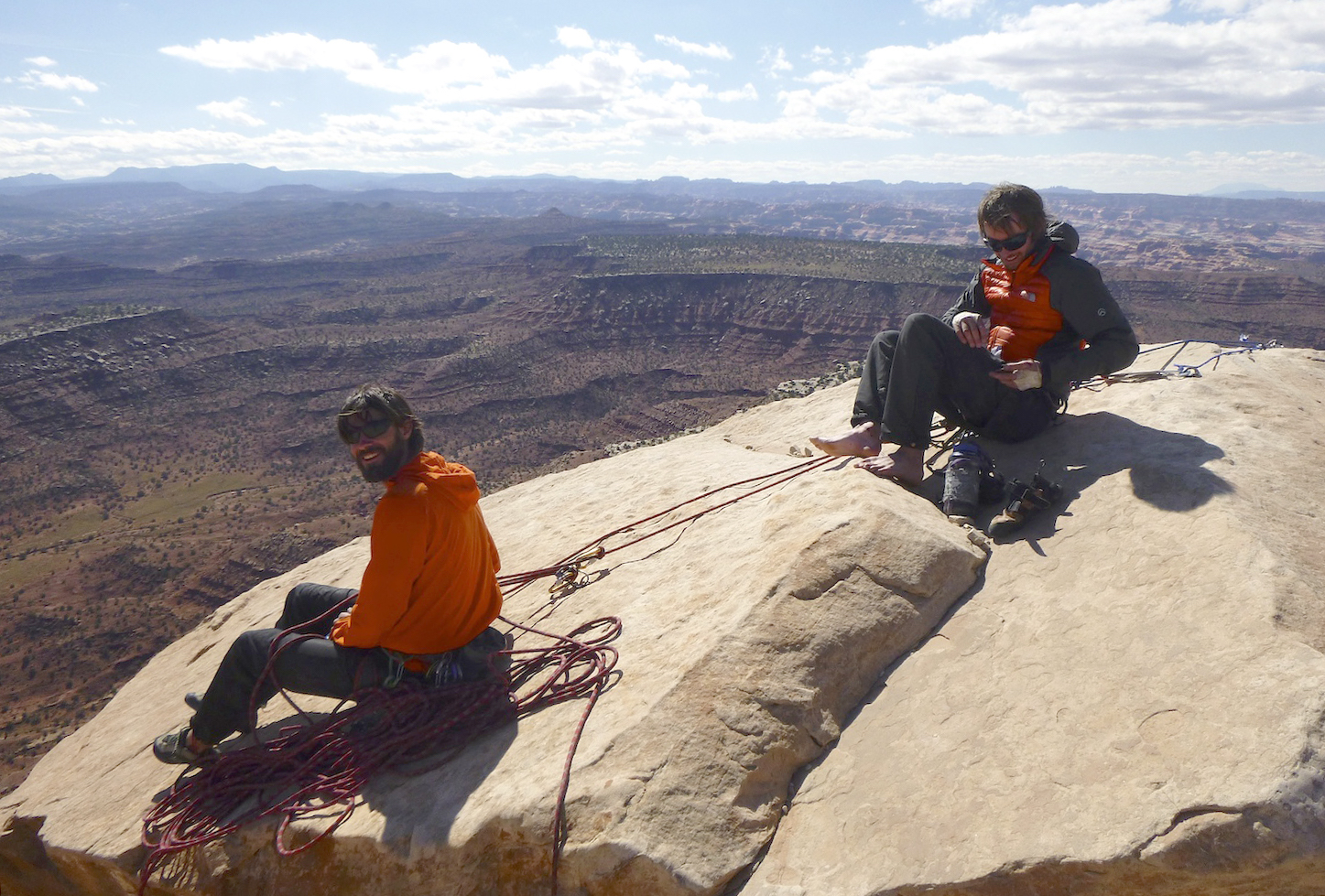 Nathan Martinez and Steve Dilk sit atop North Six Shooter in Indian Creek, Utah, in 2013. The area is now included in Bears Ears National Monument. Canyonlands National Park is in the background. [Photo] Derek Franz