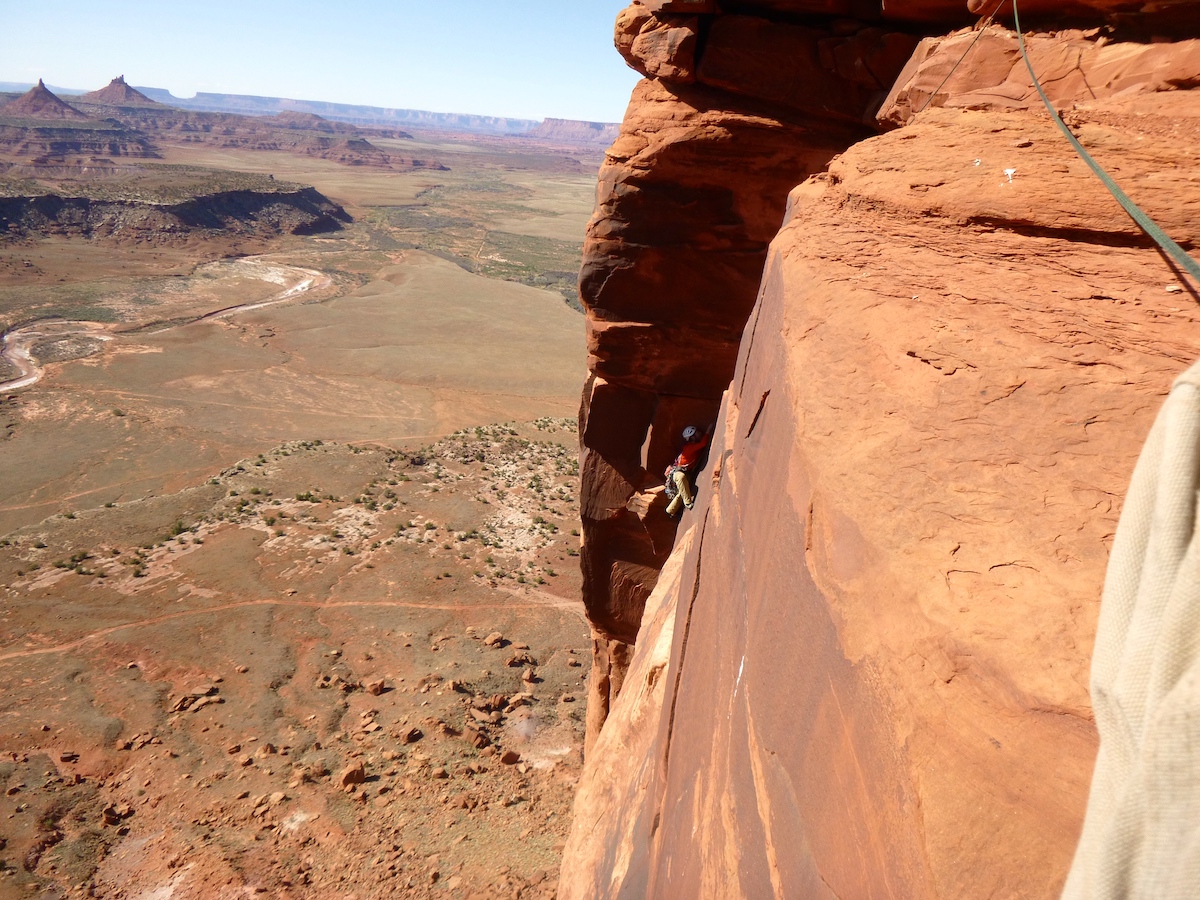 A climber nears the top of Rim Shot (5.11-, 400'), Bridger Jack Butte, Indian Creek, Utah. The area is included in the new Bears Ears National Monument, which Utah lawmakers are asking President Donald Trump to rescind. [Photo] Derek Franz