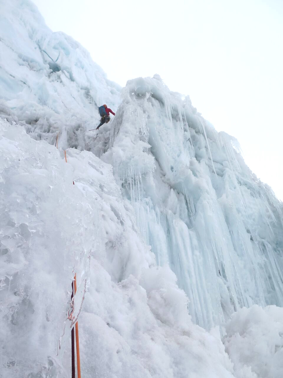 Ben Dare navigating the final overhanging ice pitch which topps out directly on the summit. [Photo] Steve Skelton