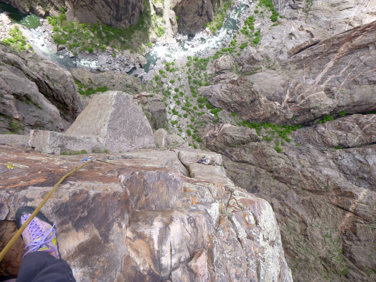 Morgan Williams enjoys a belay ledge on Modern Day Migs (III 5.10d, 7 pitches), Black Canyon of the Gunnison National Park. [Photo] Derek Franz