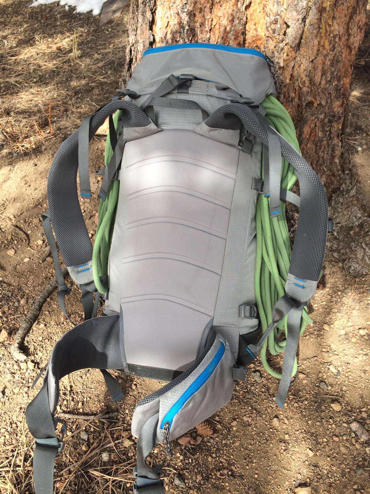 The Yeti 50L pack has a simple and streamlined, yet comfortable and durable back pad. Here, the hip-belt pocket can be seen as well as the non-releasable lower lateral compression strap down towards the bottom of the dangling rope on the right side. [Photo] Mike Lewis