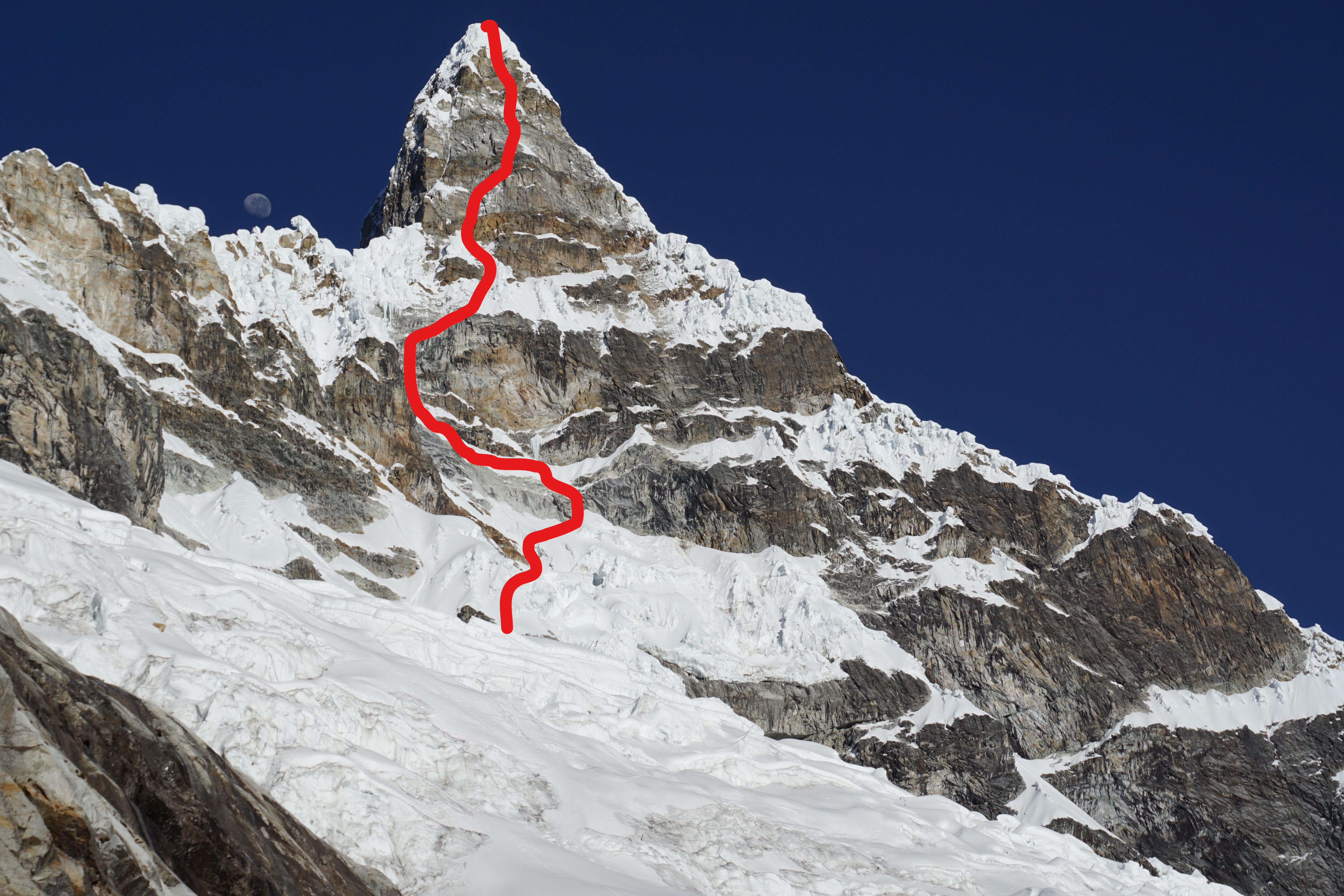 Chacraraju Este's east face with The Devil's Reach Around (M6 5.10, 90*) marked in red. [Photo] Quentin Lindfield Roberts