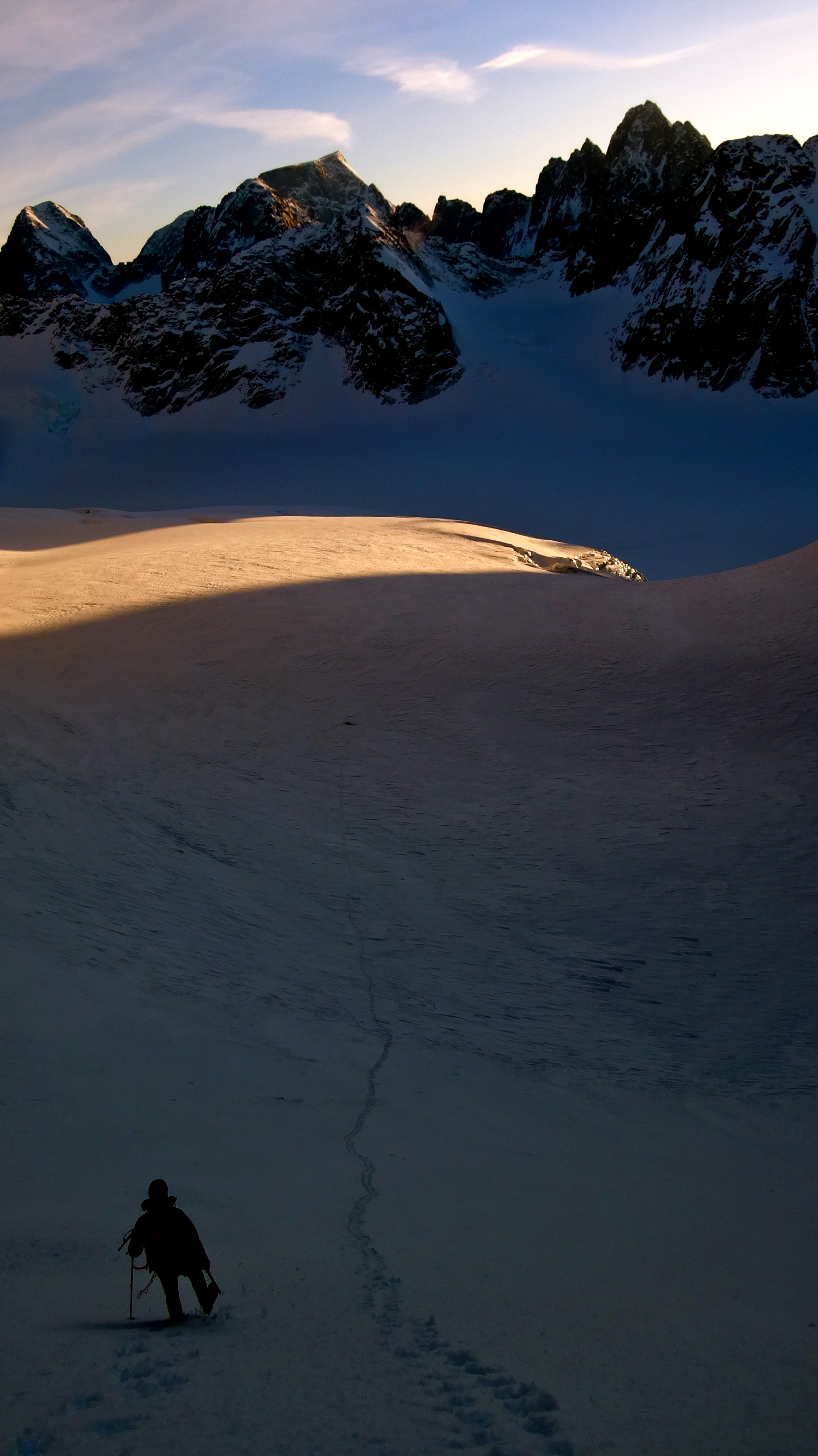 Roskelley walking down the snow slope below the new route. [Photo] Benjamin Erdmann