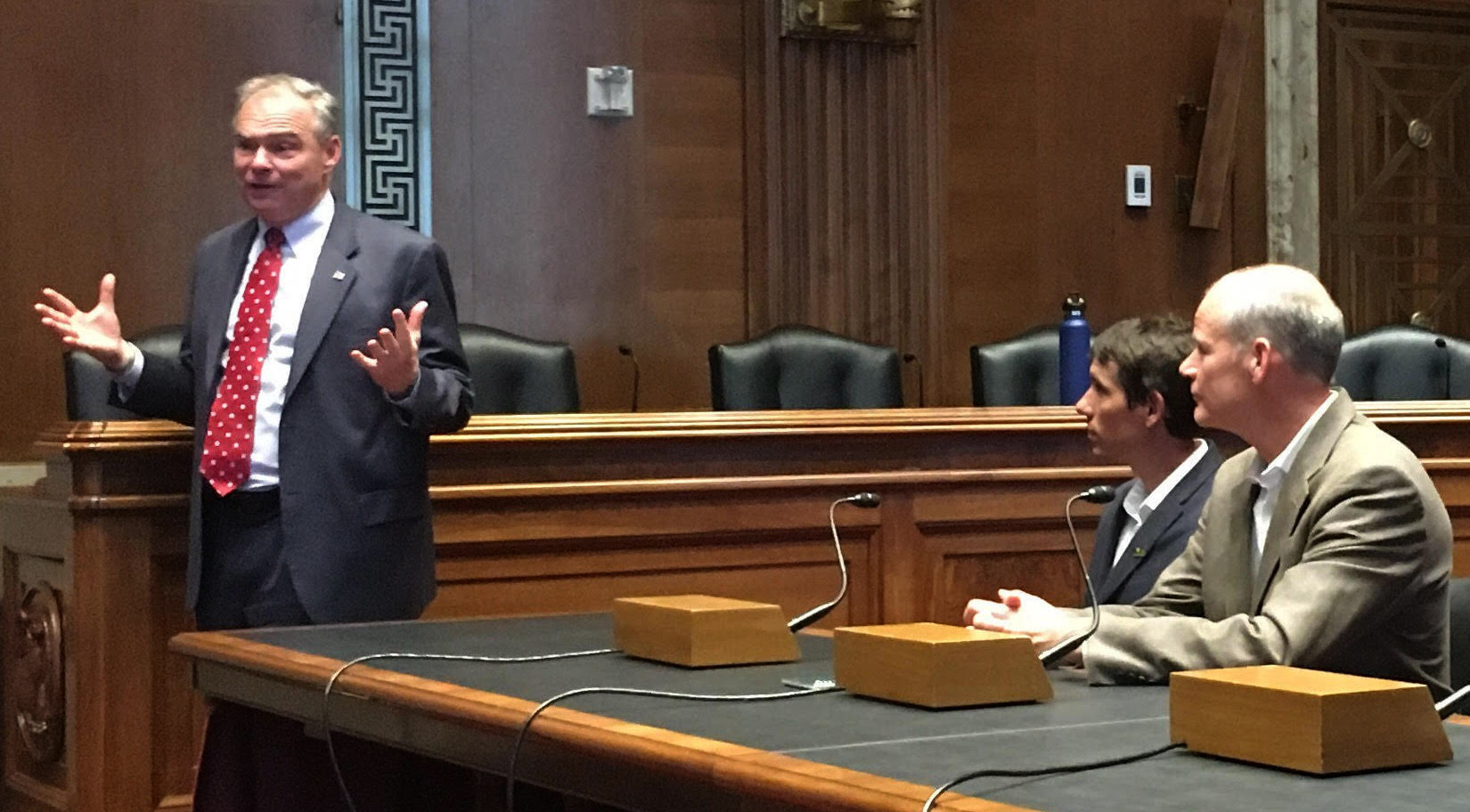 Senator Tim Kaine (D-Virginia) makes an impromptu speech at a Congressional briefing at the end of the day. Alex Honnold and Mike Gauthier, Yosemite National Park's Chief of Staff, look on. [Photo] Derek Franz