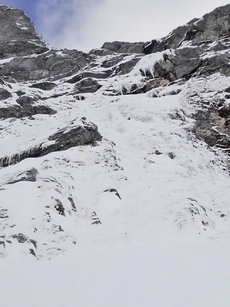 The final steep section of ice leading to the snow slopes below the North Ridge. [Photo] Ben Dare