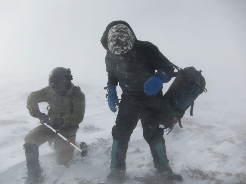 Elliot Demos and Jim Detterline battle a ground blizzard below Granite Pass, December 2011. The photographer recalls, Jim, Elliot and I climbed Longs Peak via the North Face that day. With that December descent, I became the first woman to climb Longs Peak in every month of the year. [Photo] Lisa Foster