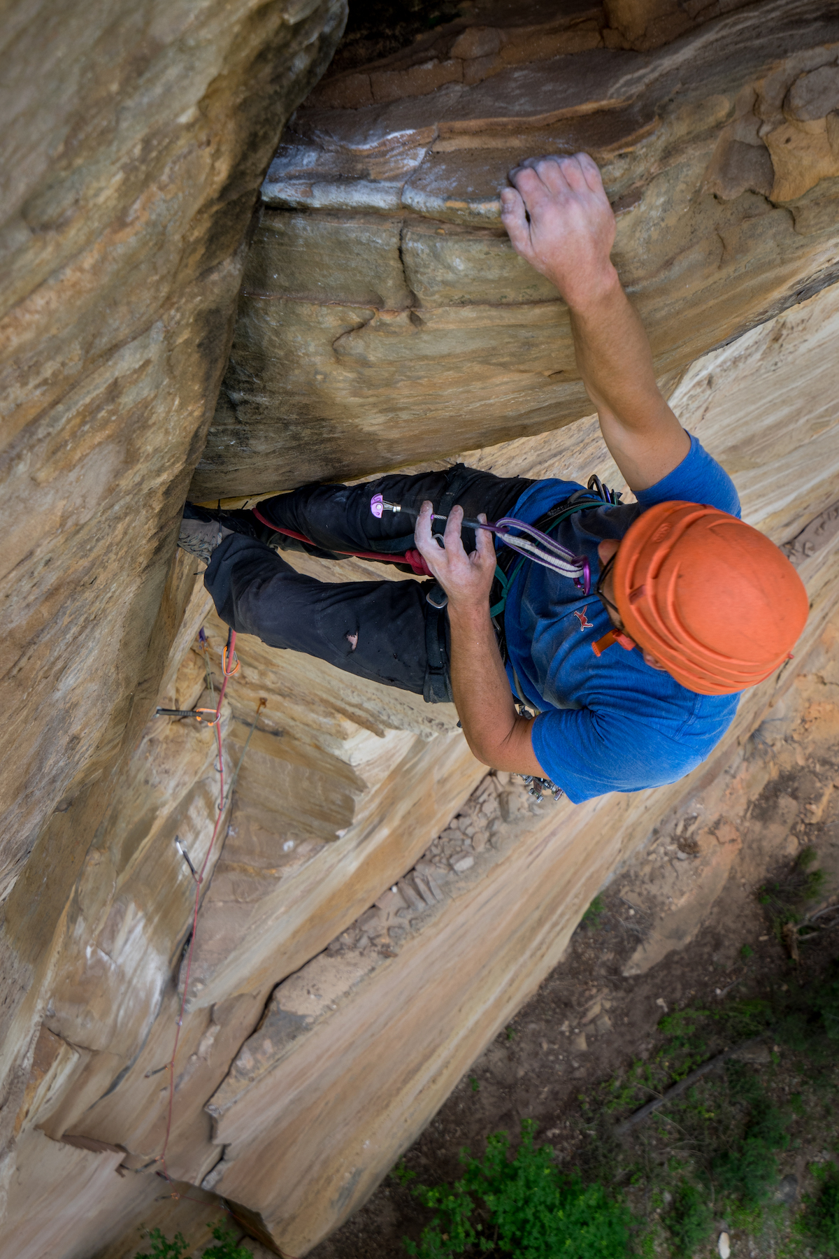 Chris Kalman placing a #6 (purple) DMM Dragonfly on a steep new route in Arizona. [Photo] Nelson Klein