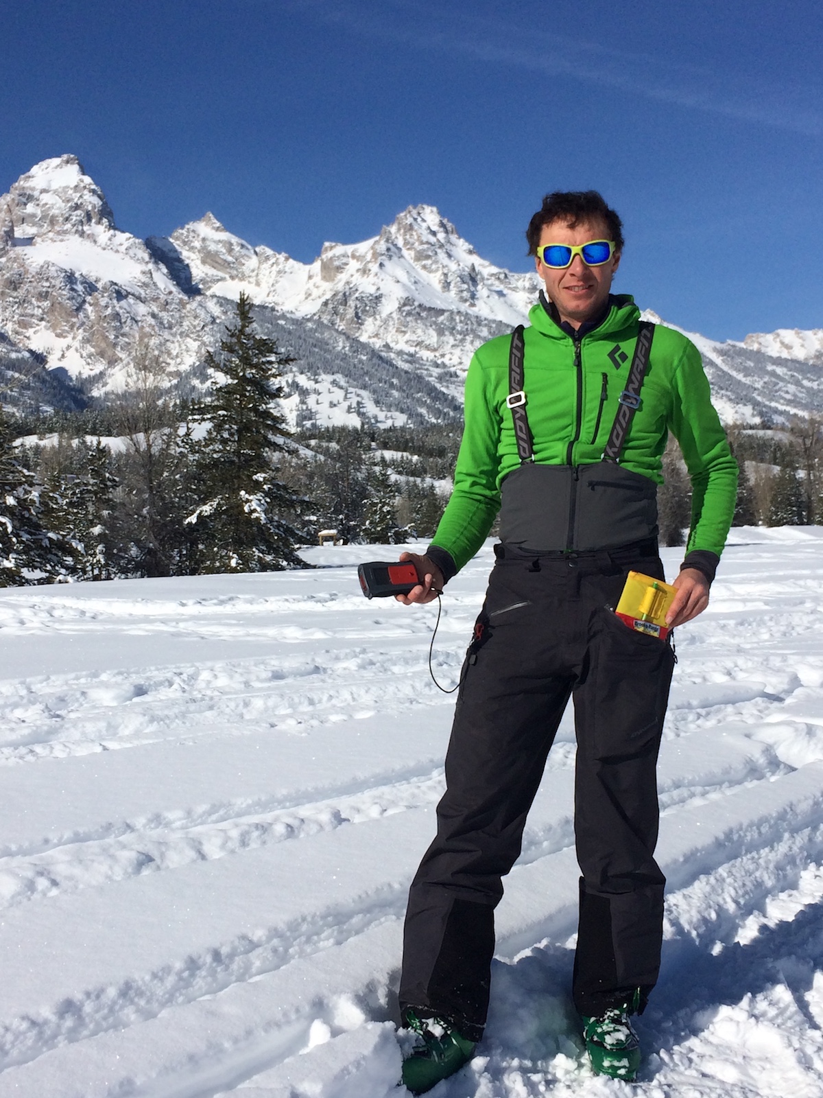 Mike Lewis demonstrates the compatibility of the Yotei Pants with an avalanche transceiver and field book during a trip to the Tetons in Wyoming. [Photo] Chris Brown