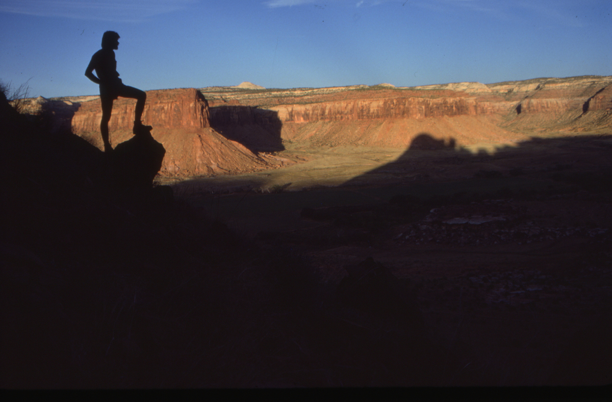 Ed Webster overlooking the valley of Indian Creek and the shadow of the Bridger Jack spires, 1984. [Photo] Jeff Achey