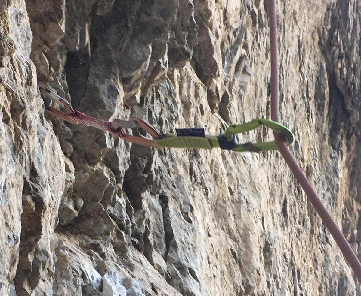 This photo shows how the angle of the rope from the belay to the first quickdraw results in more friction than if the rope were able to run straight up. Over time, this added friction causes the rope to wear a groove through aluminum (and sometimes even steel) carabiners. The Edelrid Bulletproof carabiners have a sleeve of steel to protect the softer, lighter aluminum from this kind of wear. The result is a workhorse 'biner that is much lighter than a carabiner made entirely of steel. [Photo] Derek Franz