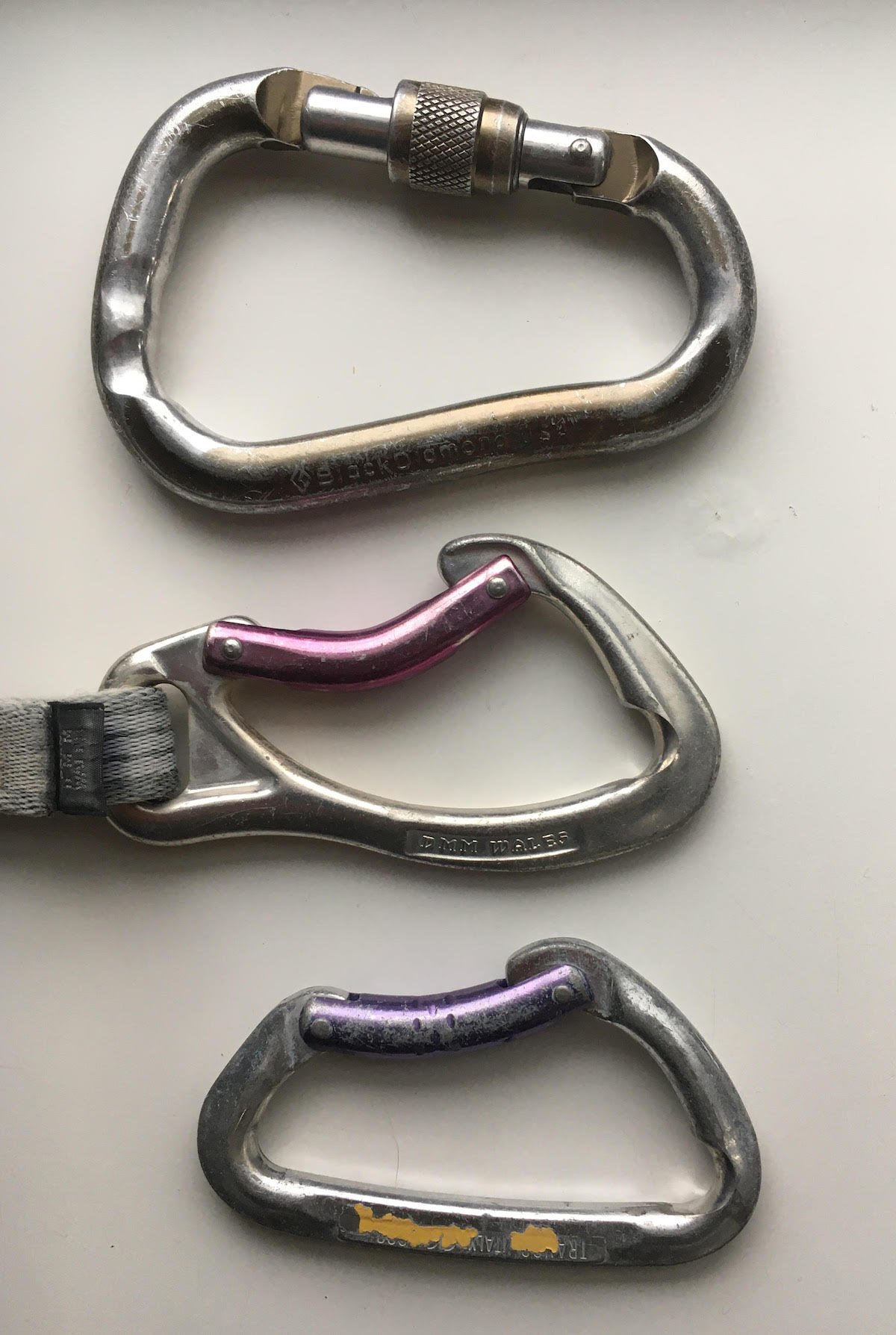 These carabiners were gouged by ropes. The top locking 'biner was used for a tube-style belay/rappel device, resulting in the double grooves. [Photo] Derek Franz