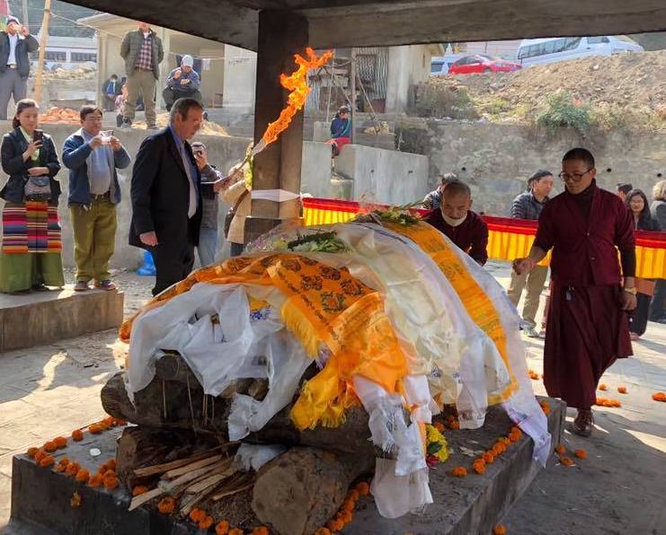 Elizabeth Hawley's nephew Michael Hawley Leonard lights her funeral pyre in Nepal. [Photo] Meg Leonard