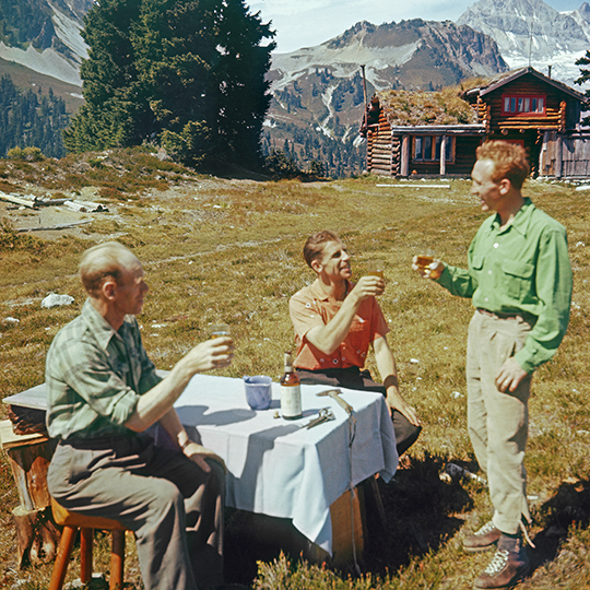 Beckey, center, MacDonald, right, both legendary climbers, sip Canadian Club whiskey after a climb, ca. 1958. Man at left is unidentified. [Photo] Ed Cooper