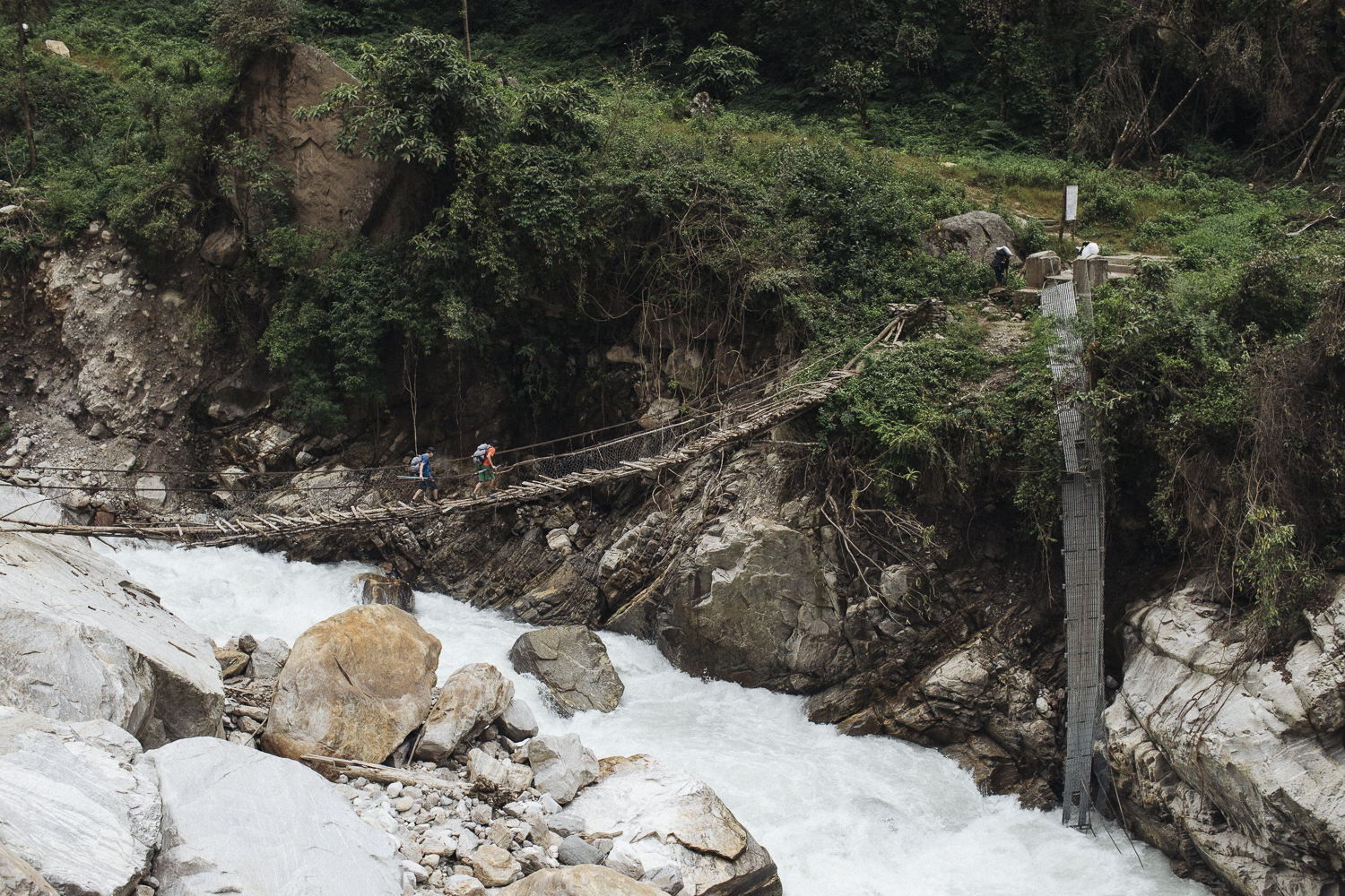 The long trek to base camp. The local people reinstalled the old bridge after the new one got swept away by a massive landslide just couple of weeks before during the heavy monsoon rain of [the 2016] season, wrote Hansjorg Auer. [Photo] Elias Holzkenecht
