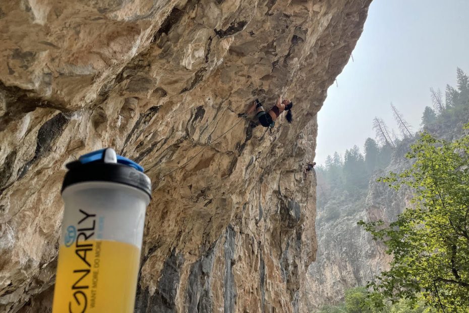 Nina Williams--who is sponsored by Gnarly Nutrition--climbs in the background of the author's BCAA supplement at Rifle Mountain Park, Colorado. [Photo] Derek Franz