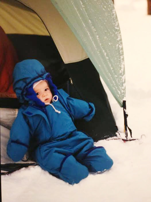 Devi, age 3 months, on a winter backpacking trip (not thrilled that the diaper wipes were frozen), 1992.