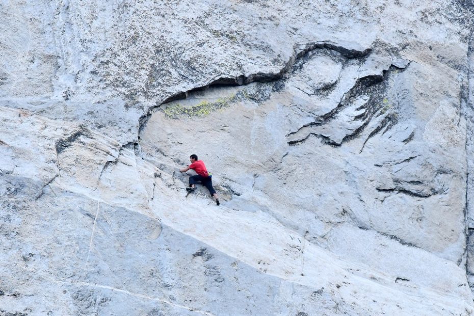 In this photo that was taken through a telescope from the ground, Alex Honnold carefully makes his way across the highly technical, friction-dependent moves low on the Freerider route (VI 5.13a, 3,000') during his historic ropeless ascent of El Capitan, June 3. [Photo] Tom Evans