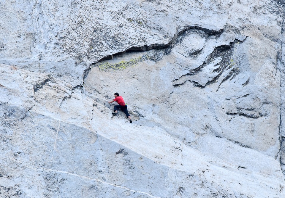 In this photo that was taken through a telescope from the ground, Alex Honnold carefully makes his way across the highly technical, friction-dependent moves low on the Freerider route (VI 5.13a, 3,000') during his historic ropeless ascent of El Capitan, June 3. [Photo] Tom Evans
