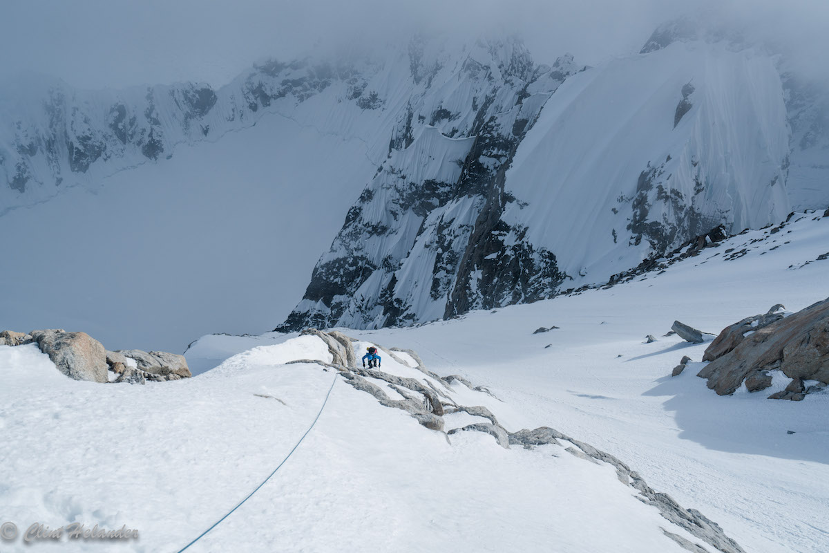 Roskelley races an incoming storm on the upper ridge. Idiot Peak is visible in the upper right. [Photo] Clint Helander