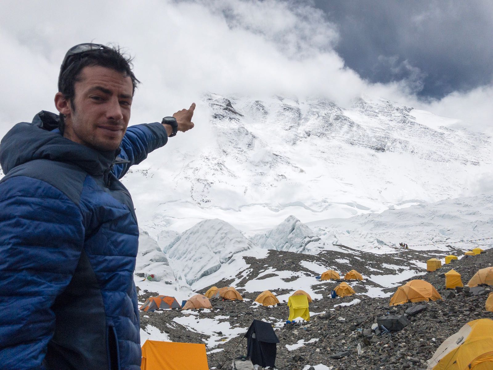 Kilian Jornet points to Mt. Everest's shrouded summit while acclimatizing for his first speed ascent of the North Col route. [Photo] Sebastien Montaz-Rosset/Kilian Jornet collection