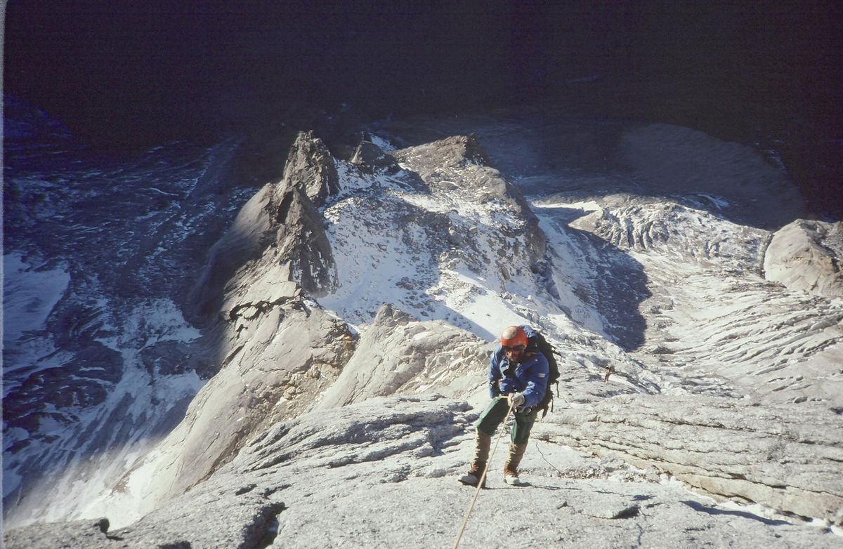Jim Kanzler rappelling off the north face of Mt Siguniang. [Photo] Jack Tackle, Kim Schmitz collection