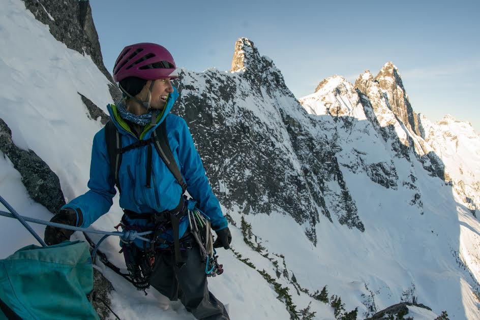 Brette Harrington on Labour Day Horn, one of Mt. Slesse's satellite peaks. On Instagram, her partner Kieran Brownie wrote, We topped out early and decided to traverse the ridge to take a look at Station D (the peak just over Brette's shoulder). We reached the summit in the blue hues of dusk to find a stunning view of the Cascades; a sprawling vista of pristine mountains, a place where the imagination can run free. [Photo] Kieran Brownie