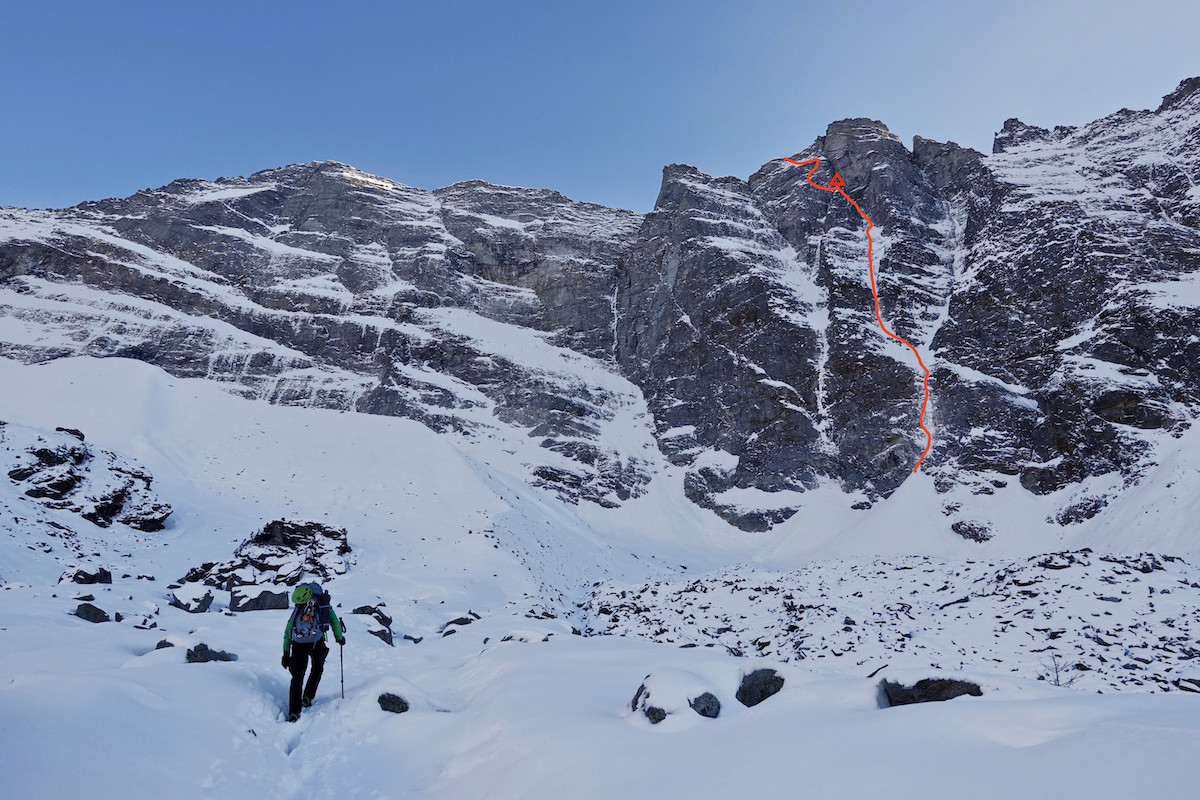 Approaching the north face of the Sagwand, Valsertal, Austria. The red line shows Papert and Lindic's new route Limited in Freedom (AI6 M6, 800m). The location of their bivouac is marked with a triangle near the top. [Photo] Luka Lindic