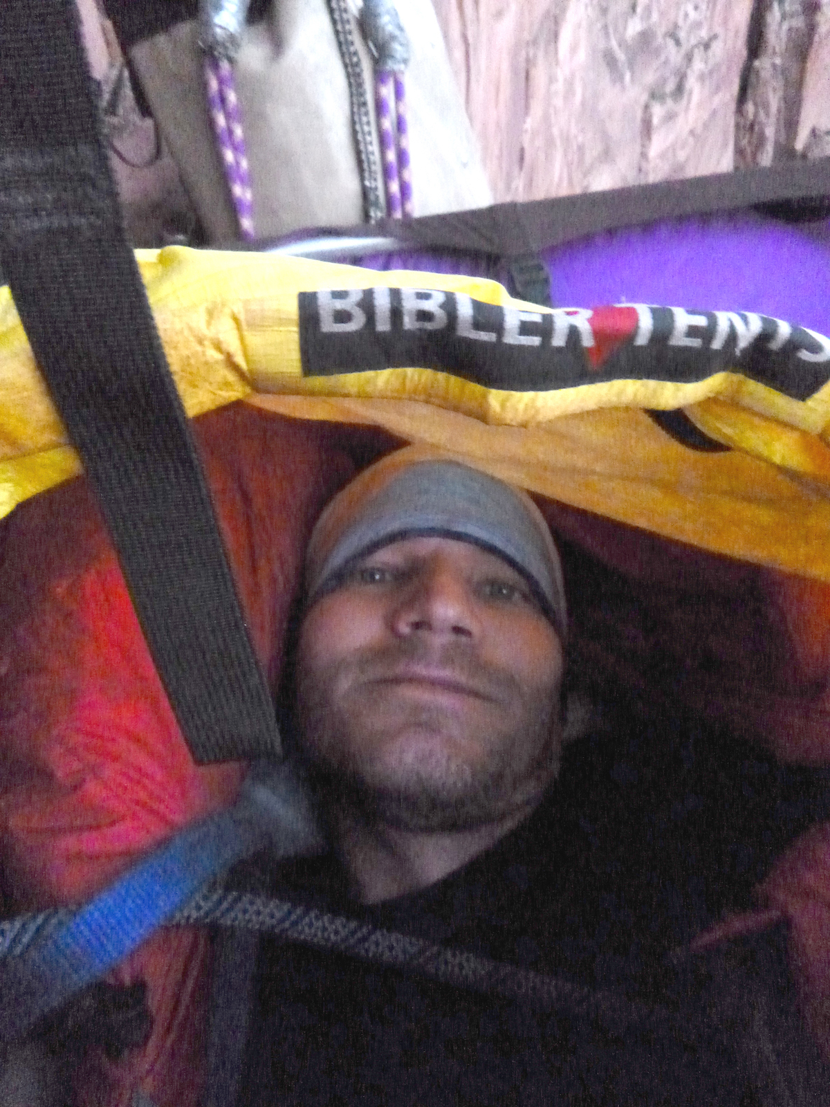 The author enjoys the comfort of the Mountain Equipment Xeros 800-fill, Russian Goose Down sleeping bag inside his bivy sack on the second morning of his solo ascent of Prodigal Sun (V 5.7 C2, 900') in Zion National Park, October 22. [Photo] Derek Franz