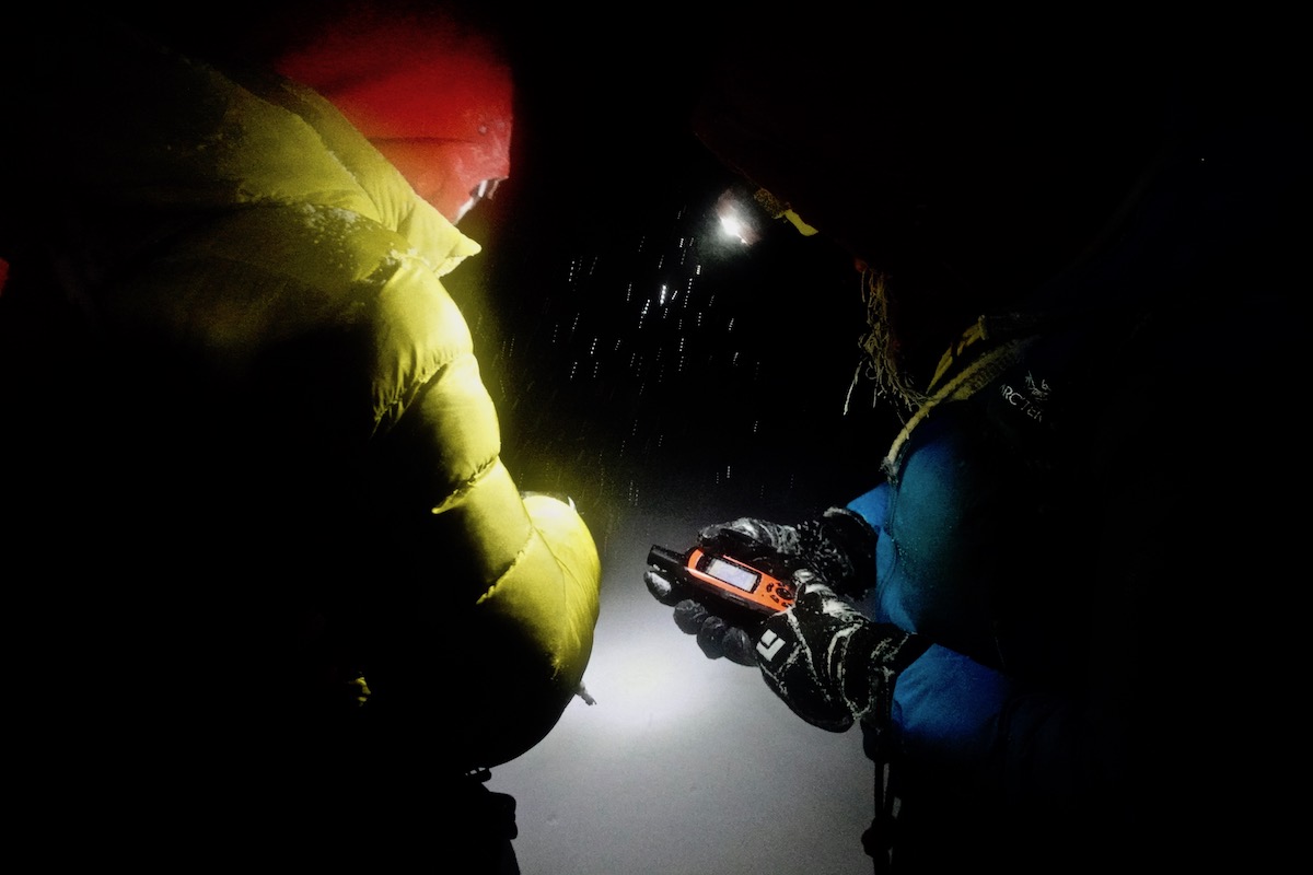Lindic and Papert using a GPS to find the hut. [Photo] Brette Harrington
