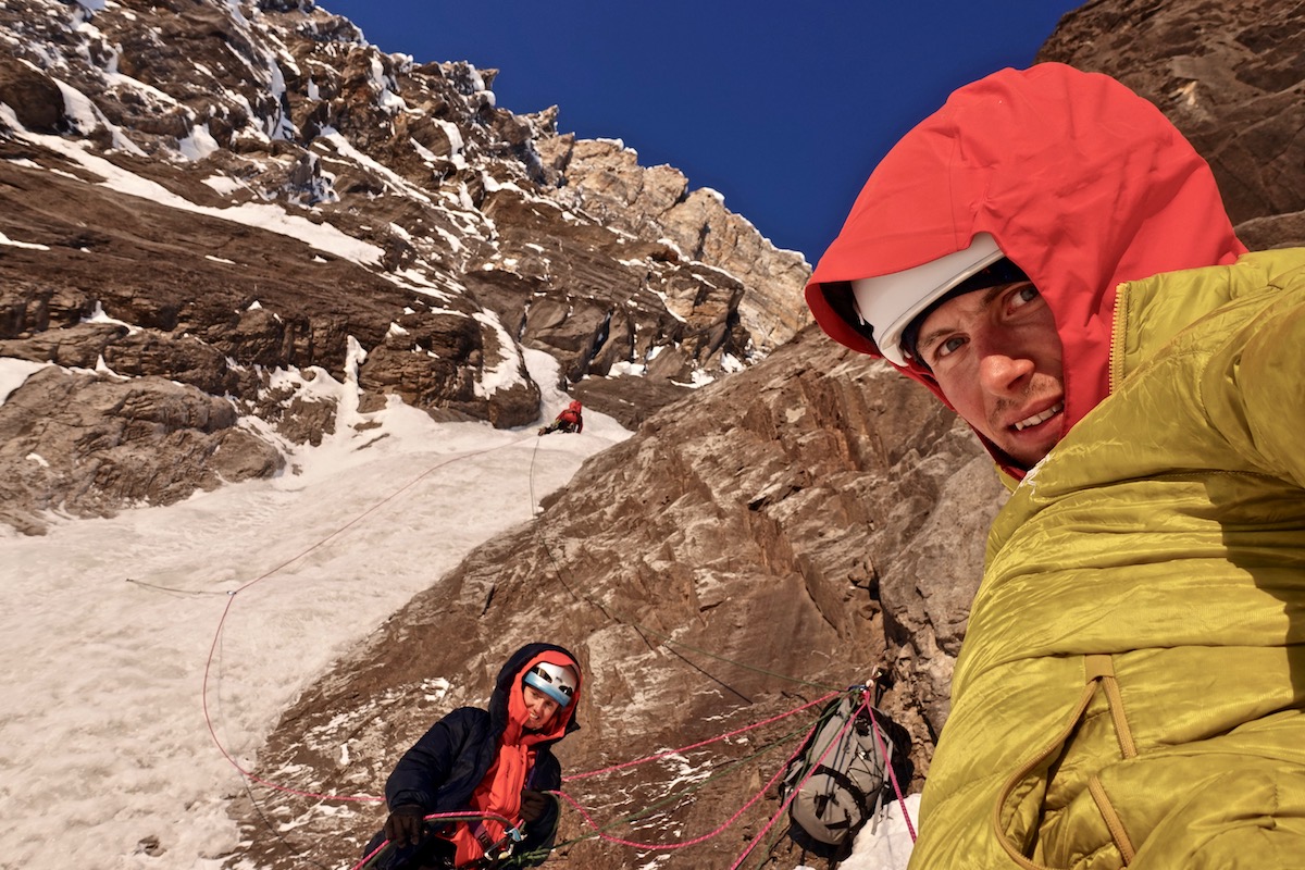 Brette Harrington and Luka Lindic enjoy the first morning sun at the belay while Ines Papert leads a pitch in the middle of the wall. [Photo] Luka Lindic