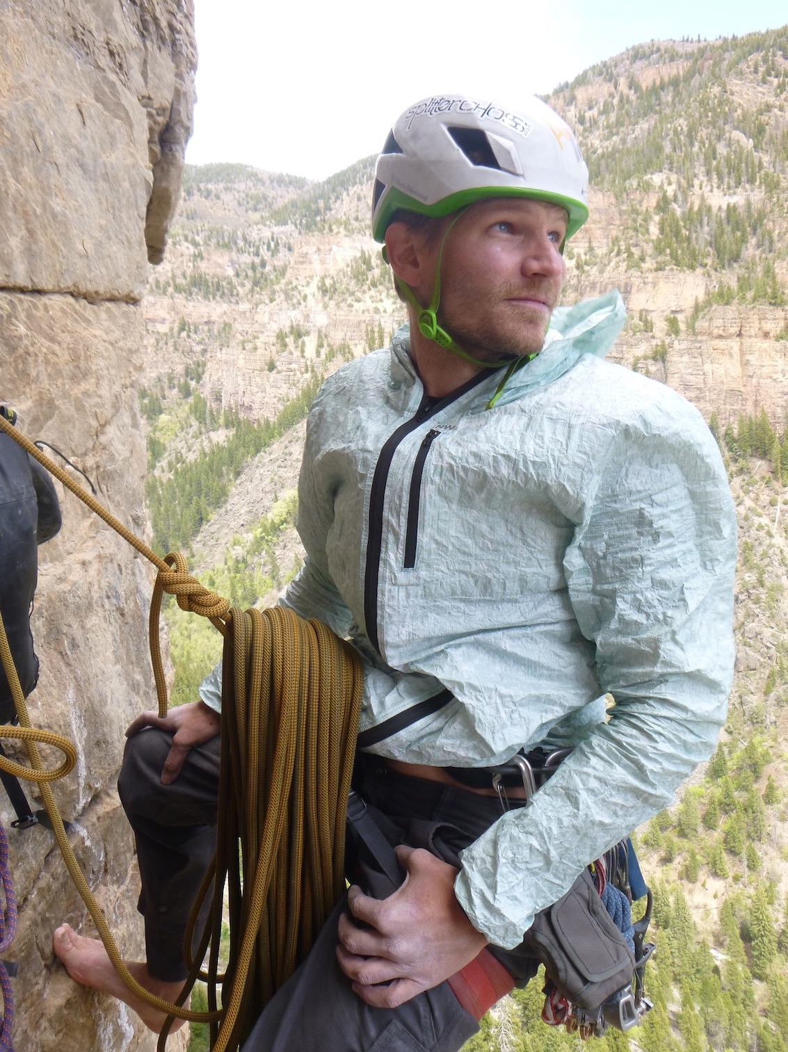 Derek Franz stays warm at a breezy belay with NW Alpine's Eyebright jacket atop Pitch 4 of Horse and Pony Show (III 5.11d) on the obscure Grizzly Creek Wall in Glenwood Canyon, Colorado. [Photo] Craig Helm