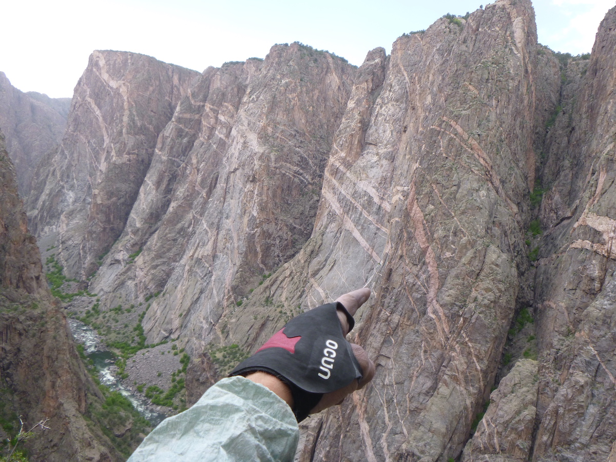 Sporting the Ocun Crack Gloves in the Black Canyon while pointing at climbers on the Russian Arete. [Photo] Derek Franz
