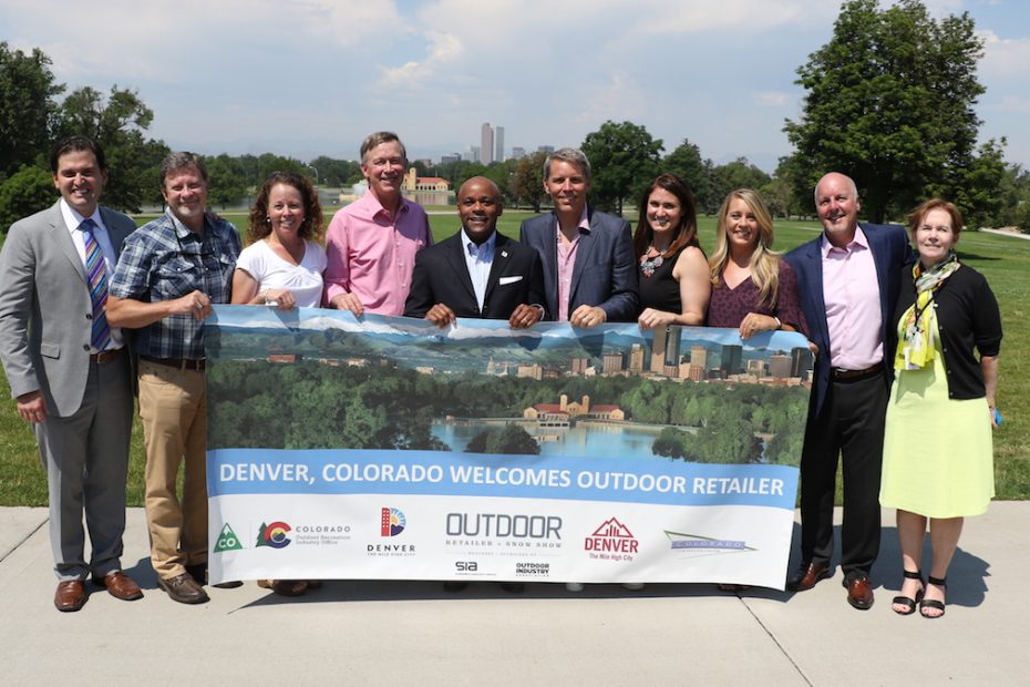 A deal was confirmed today that the summer Outdoor Retailer trade show will move to Denver, Colorado, next year. Pictured from left to right are Luis Benitez, director of Colorado's Outdoor Recreation Industry Office; Darrell Denny, executive vice president of Emerald Expositions; Amy Roberts, executive director, Outdoor Industry Association; Governor John Hickenlooper; Mayor Michael Hancock; Nick Sargent, president of SnowSports Industries America; Rachel Benedick, VP sales and service, Visit Denver; Marisa Nicholson, Outdoor Retailer show director; Richard Scharf, president and CEO, Visit Denver; Lieutenant Governor Donna Lynne. [Photo] Courtesy of Ground Floor Media