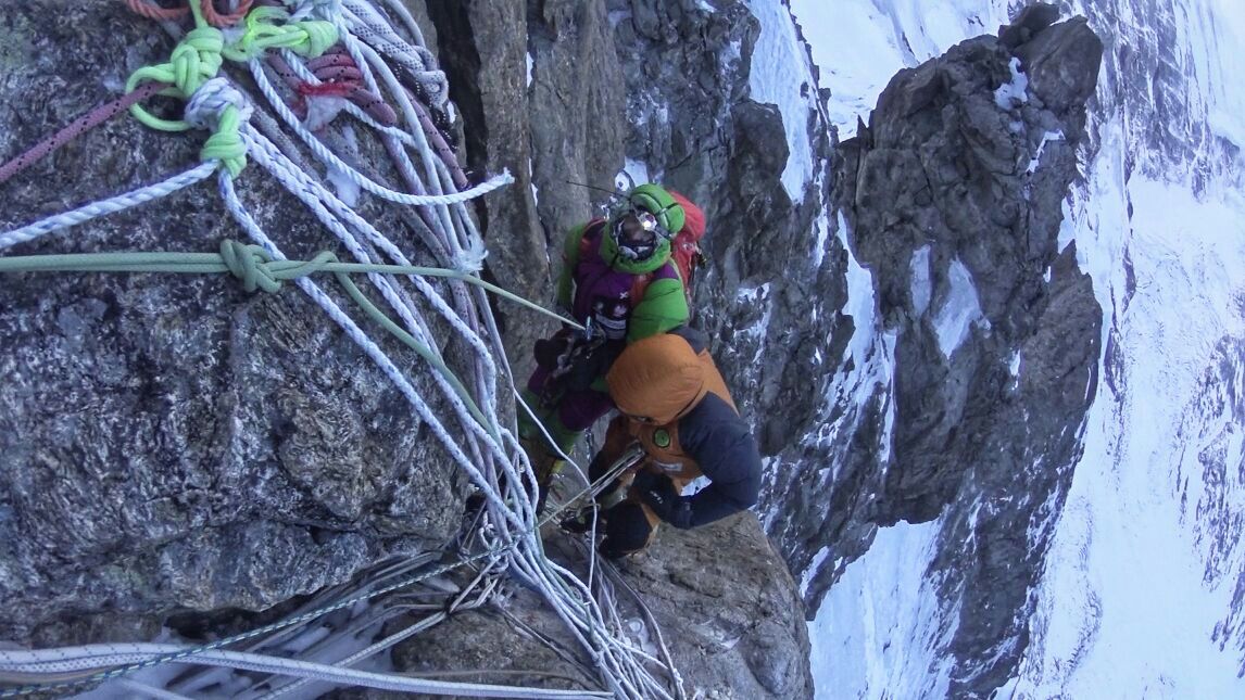 Descending fixed ropes on the Kinshofer Route. Revol's hands were so frozen that she could not safely control the rope during rappels and had to be lowered down some sections as Denis Urubko and Adam Bielecki took turns descending with her. [Photo] Courtesy of Denis Urubko
