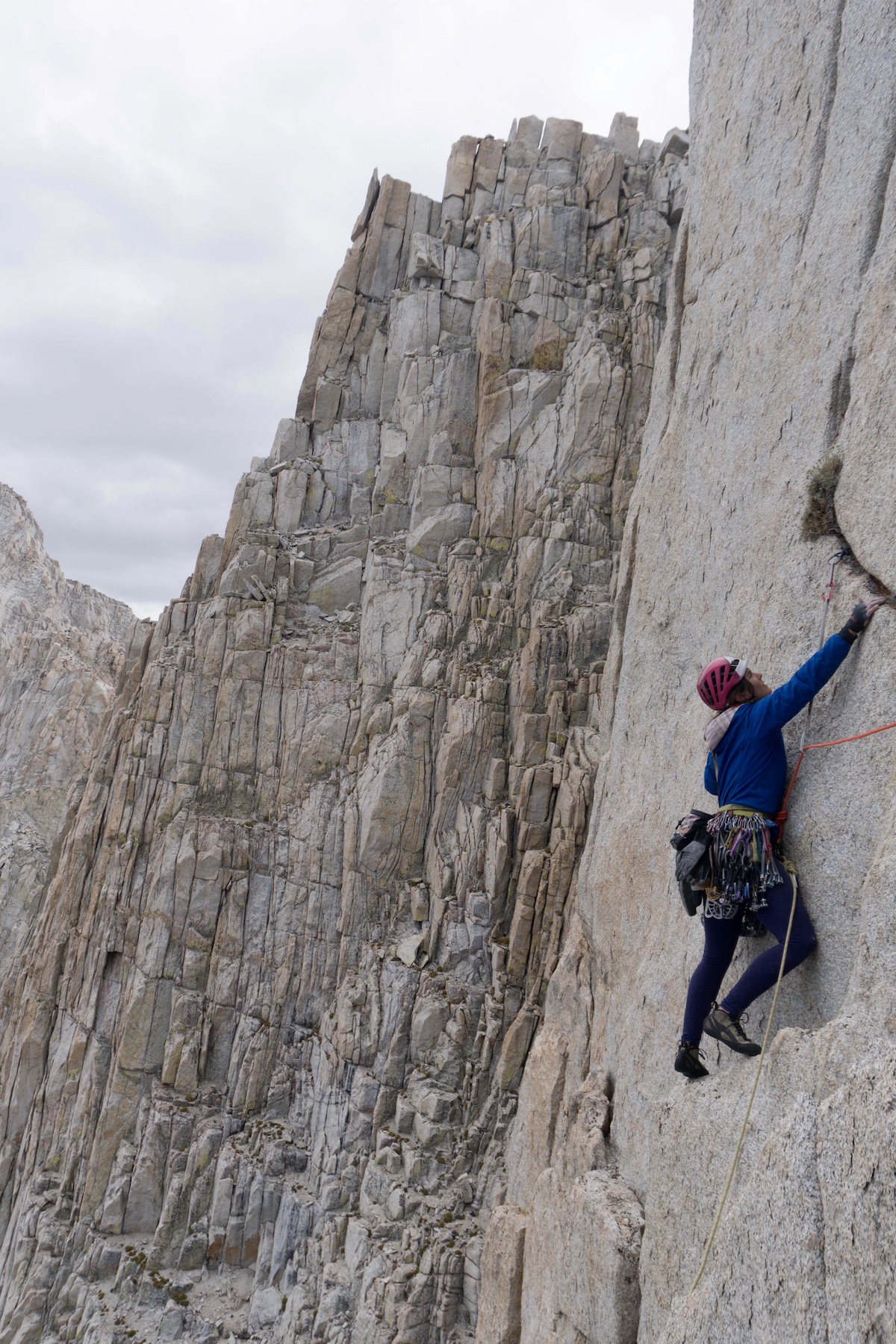 Whitney Clark wears the Patagonia Nano-Air Light Hoody while leading a pitch on the first ascent of High Fashion (5.10, 1,000') on a peak near Wales Lake in the Sierra Nevada Range. The team found a tiny pill container that contained a summit register and identified the mountain as Wales Lake Peak. The register only had two ascents from teams who walked up the backside, Clark said. [Photo] Tad McCrea