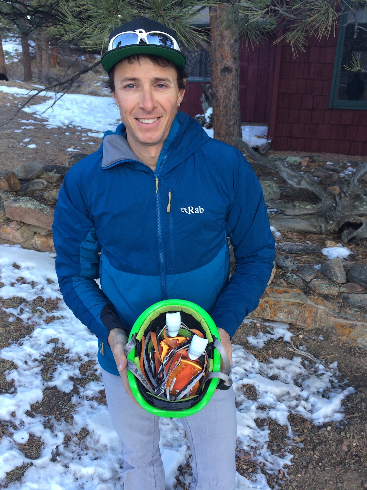 Mike Lewis shows how the Irvis Hybrid Crampons easily fit in a helmet. [Photo] Chris Wood