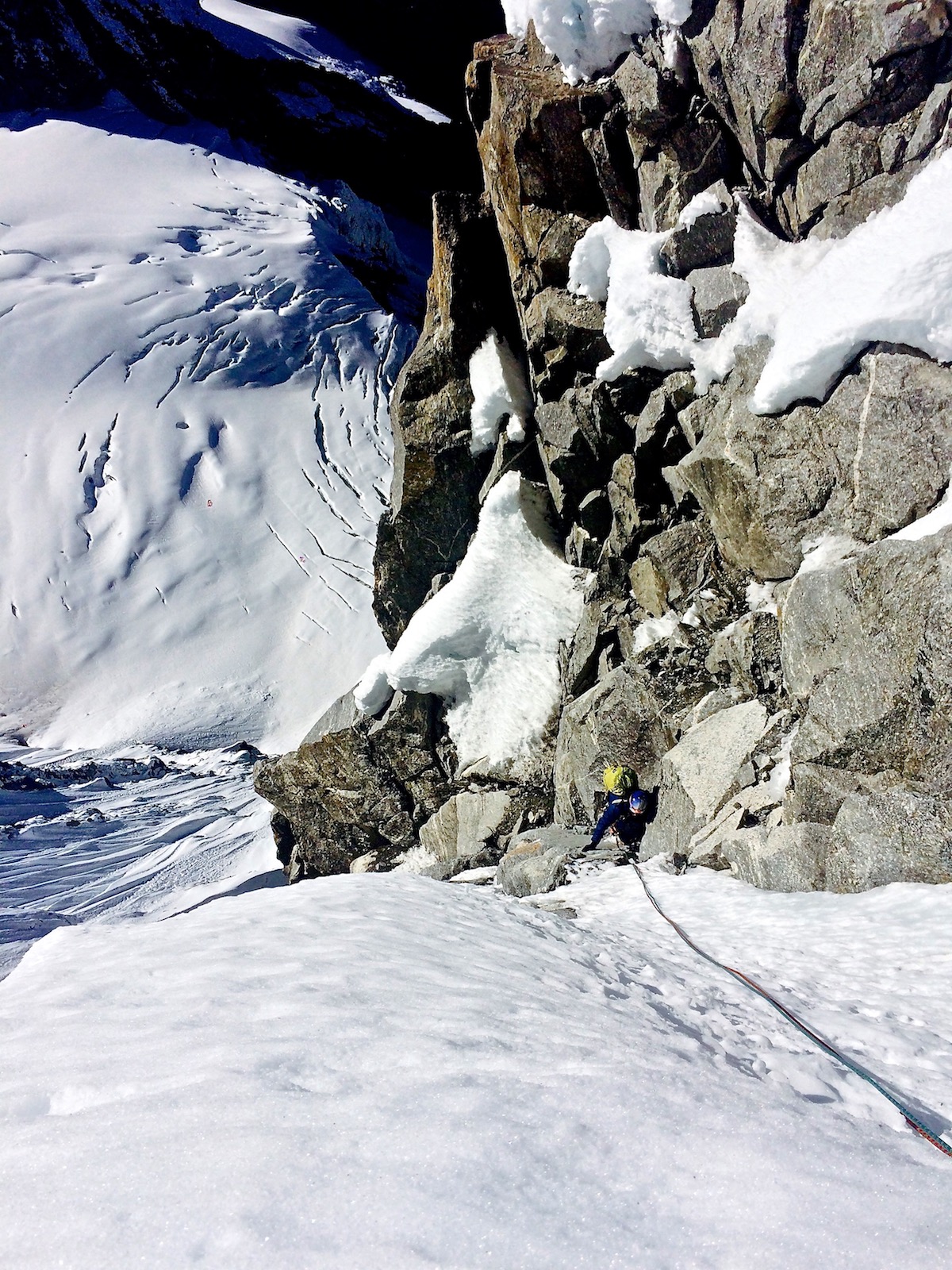 Mirhashemi follows one of the M5 pitches on the headwall of Chugimago's west face during the first ascent of Mixed Emotions (M6 AI5, 80 degrees, 900m). [Photo] Mark Pugliese