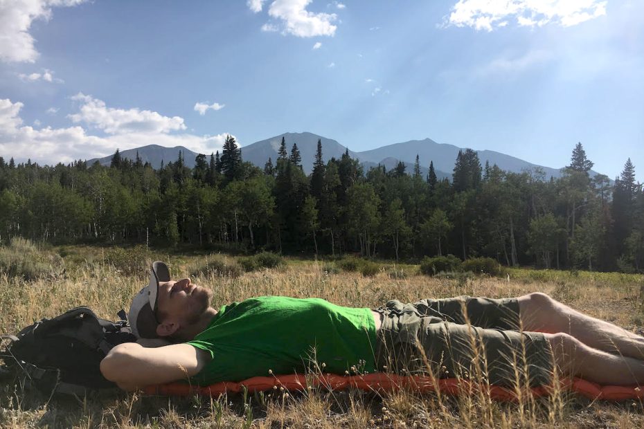The author lounges on the Sea to Summit Ultralight Air Mat in Colorado's Elk Range with Mt. Sopris (12,965') in the background. [Photo] Amanda Franz